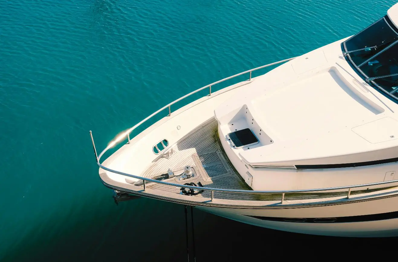 A boat is docked in the water near some steps.